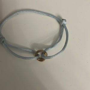 Cartier Trinity with a light blue string